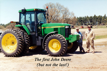 John Thompson and RJ Thompson with their first John Deere tractor