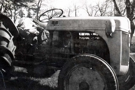 John Thompson and sister Judy riding their Dad's tractor